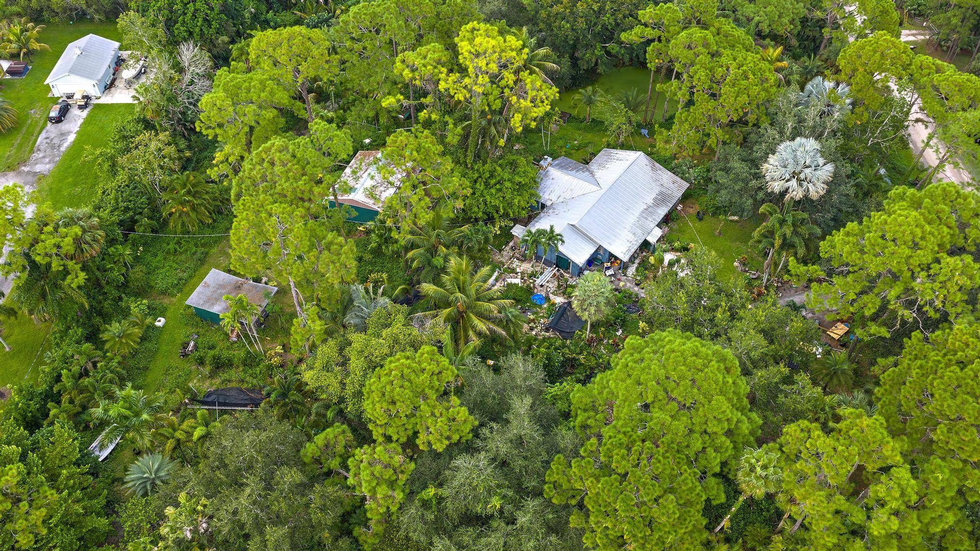 Experience the best of Jupiter Farms living on this beautiful 2.