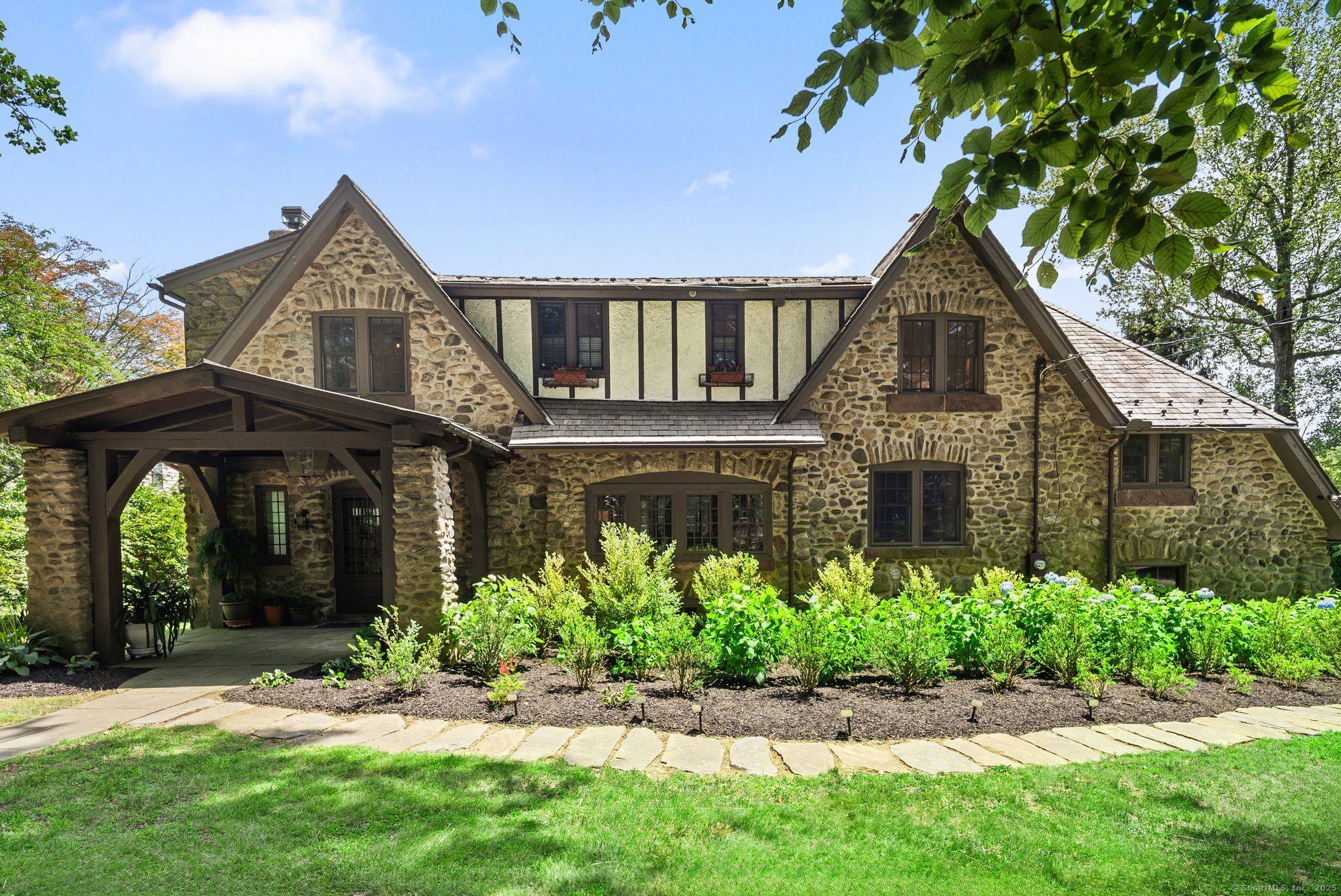 Truly One of a Kind. This iconic Fairfield Tudor Revival blends rich architectural heritage with elevated modern luxury.