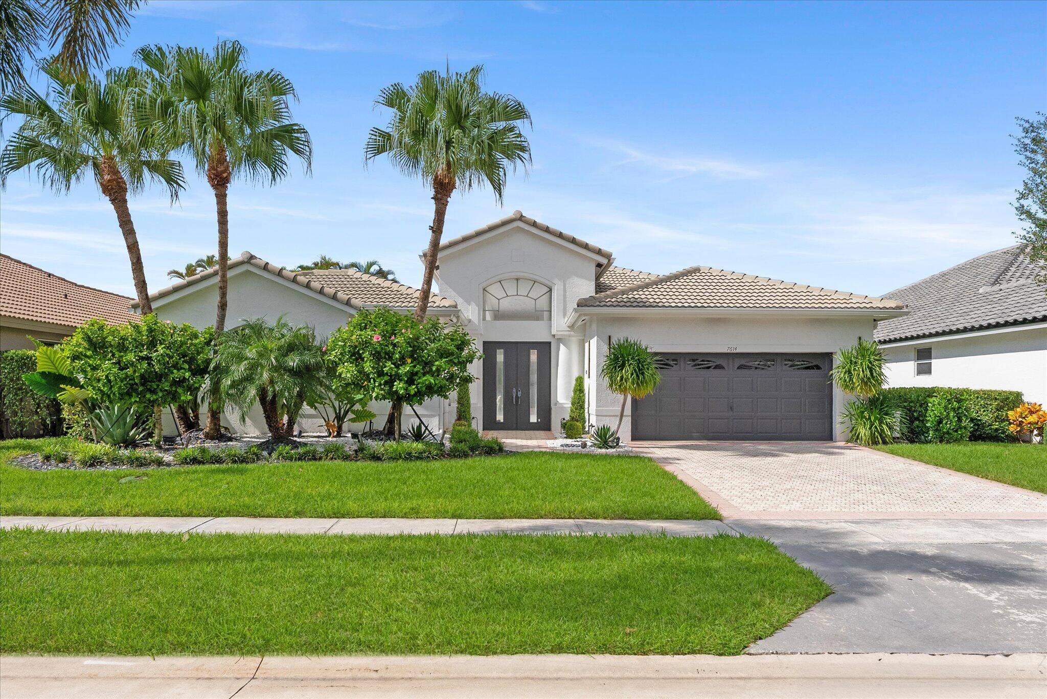 Step into modern elegance in this beautifully updated courtyard home in the sought after La Corniche community at Boca Pointe.