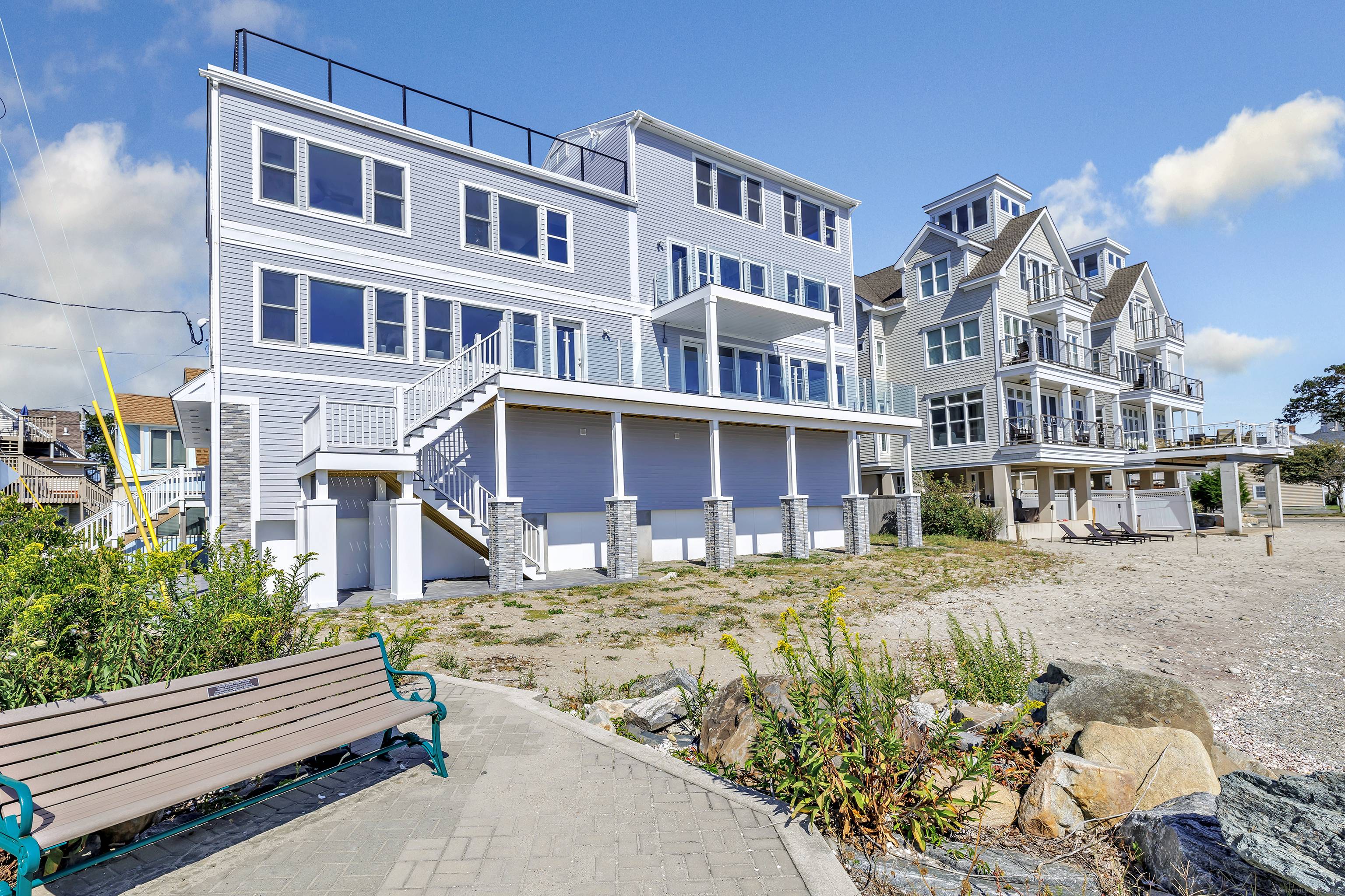 Beachfront Luxury with Panoramic Water Views !