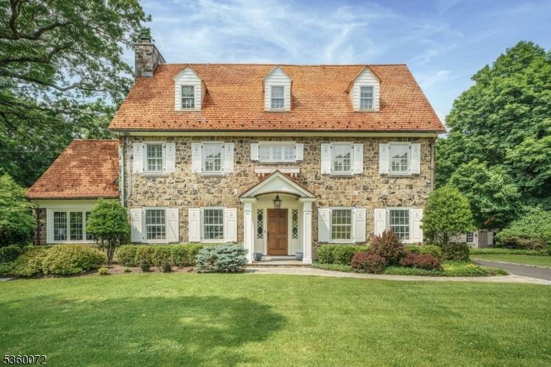 Situated on nearly an acre in Old Short Hills, this timeless fieldstone Colonial offers a rare balance of architectural significance and livability.