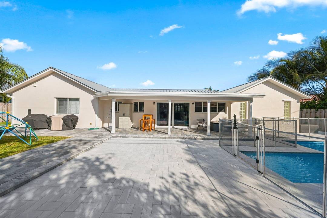Spacious 4 bedroom pool home in the heart of Lighthouse Point with a rare triple split floor plan designed for both privacy and functionality.