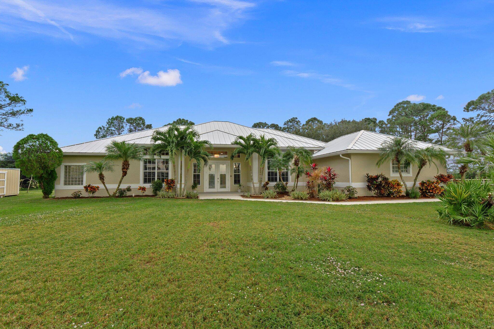 Welcome to your dream home in the exclusive gated equestrian community of Stuart West.