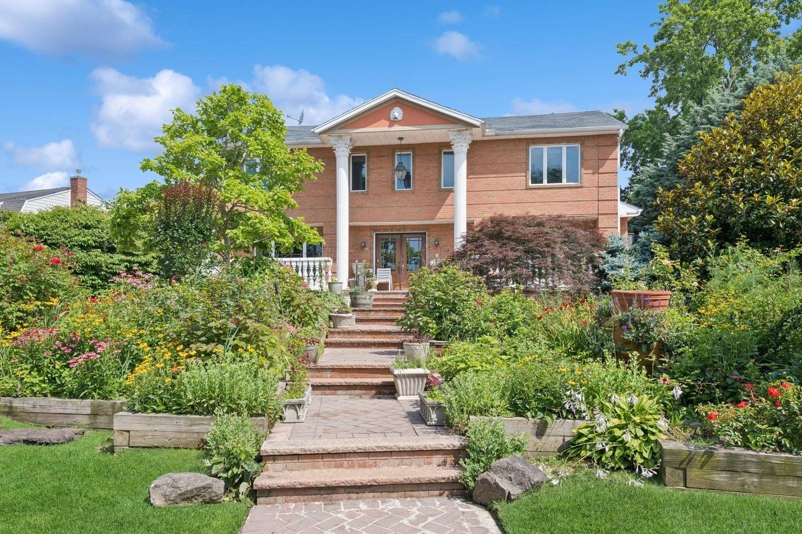 Stately 7 Bedroom, 7 Bath Brick Estate with Water Views in Prime Woodsburgh Location.