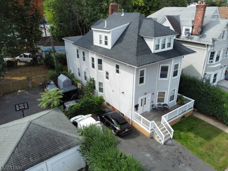 Welcome to this beautifully renovated 3 family home in the heart of Downtown East Orange.