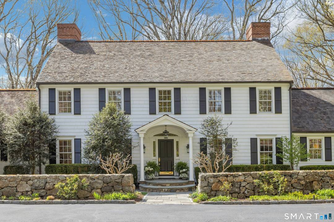 Nestled on a quiet cul de sac on a private lane, 46 Wakeman Road is a quintessential Country Colonial set on 4 beautifully landscaped acres.