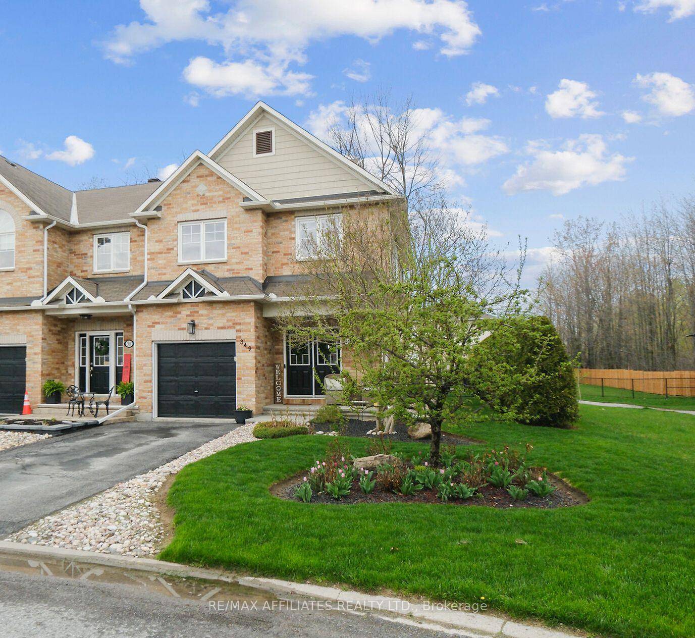 What a rare find ! This Holitzner end unit sits on a premium lot and even has its own driveway !