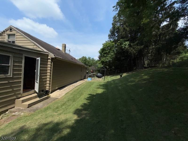 Welcome to this charming home perched on high ground with a beautiful and calming view of Farms View Garden !