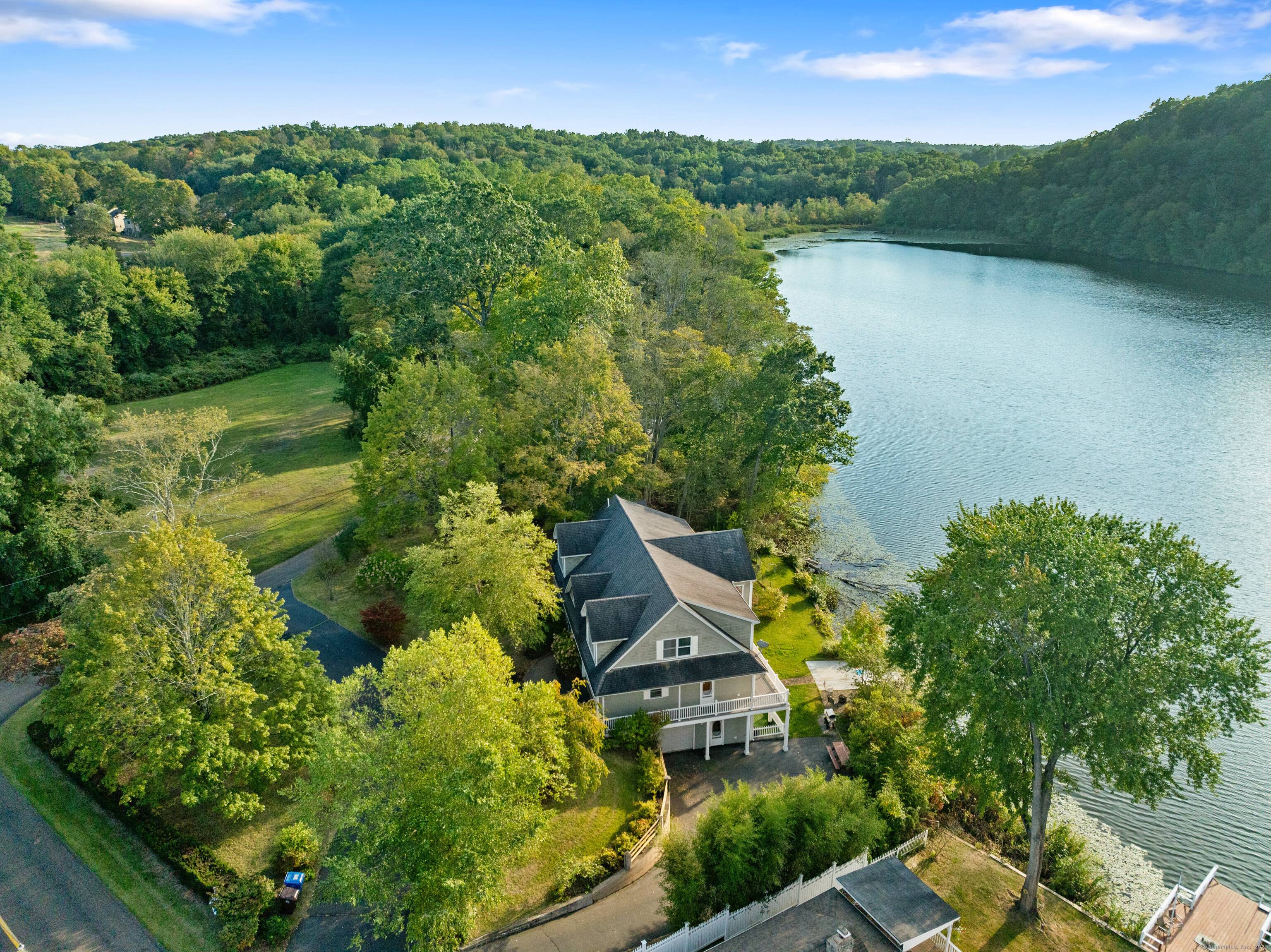 This stunning property offers a tranquil setting reminiscent of Walden Pond, showcasing breathtaking views of all four seasons.