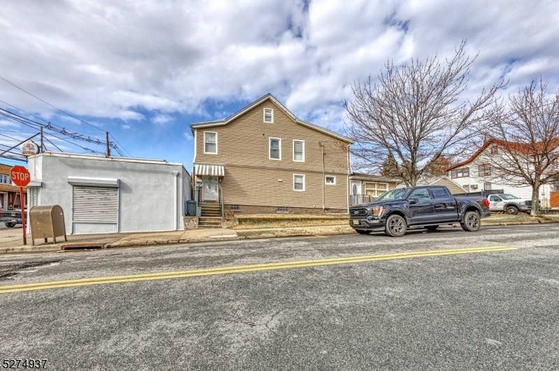 Two family home plus an additional commercial building on lot.