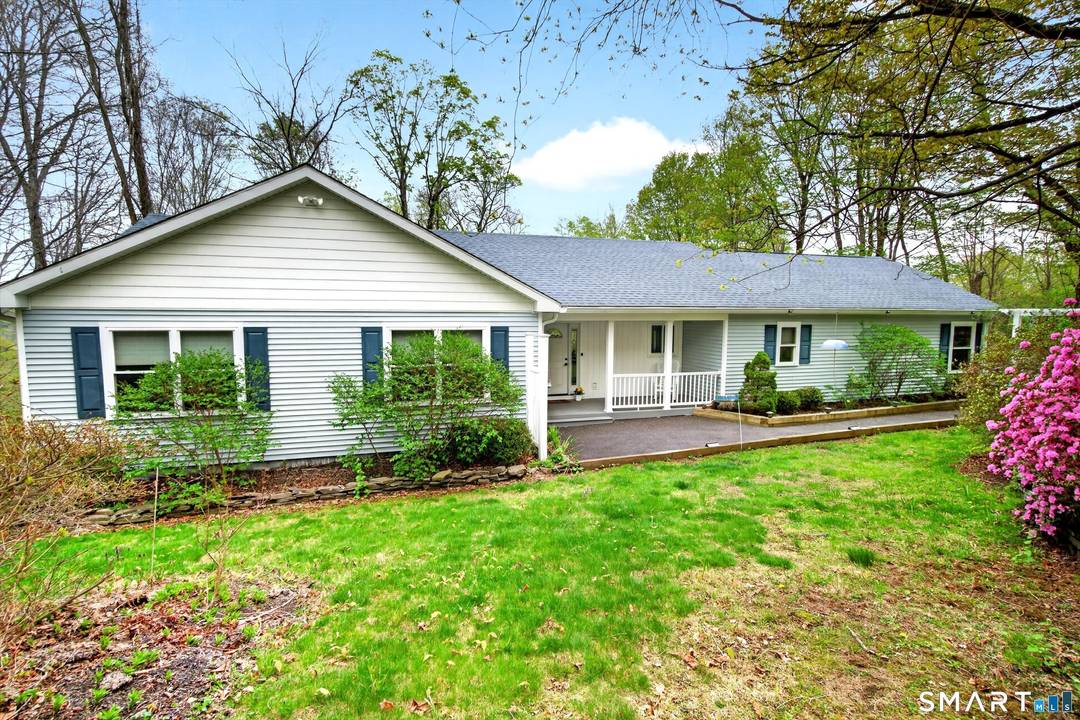 Discover the perfect blend of comfort, convenience, and seasonal beauty in this privately sited ranch home with seasonal views of Candlewood Lake.