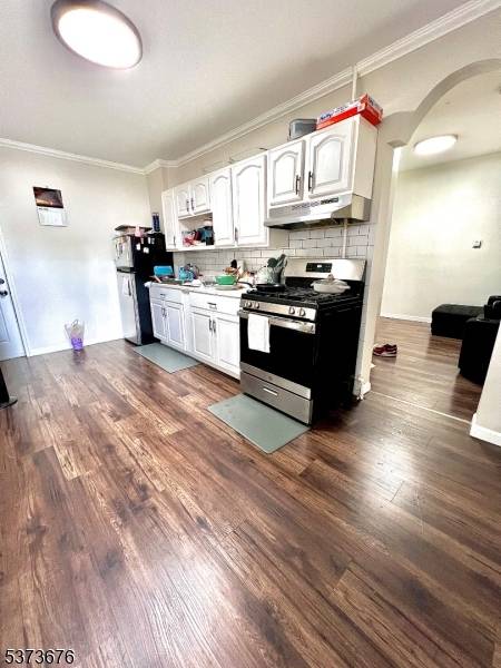 Welcome to this renovated legal two family home, perfectly situated in a convenient location in Paterson.