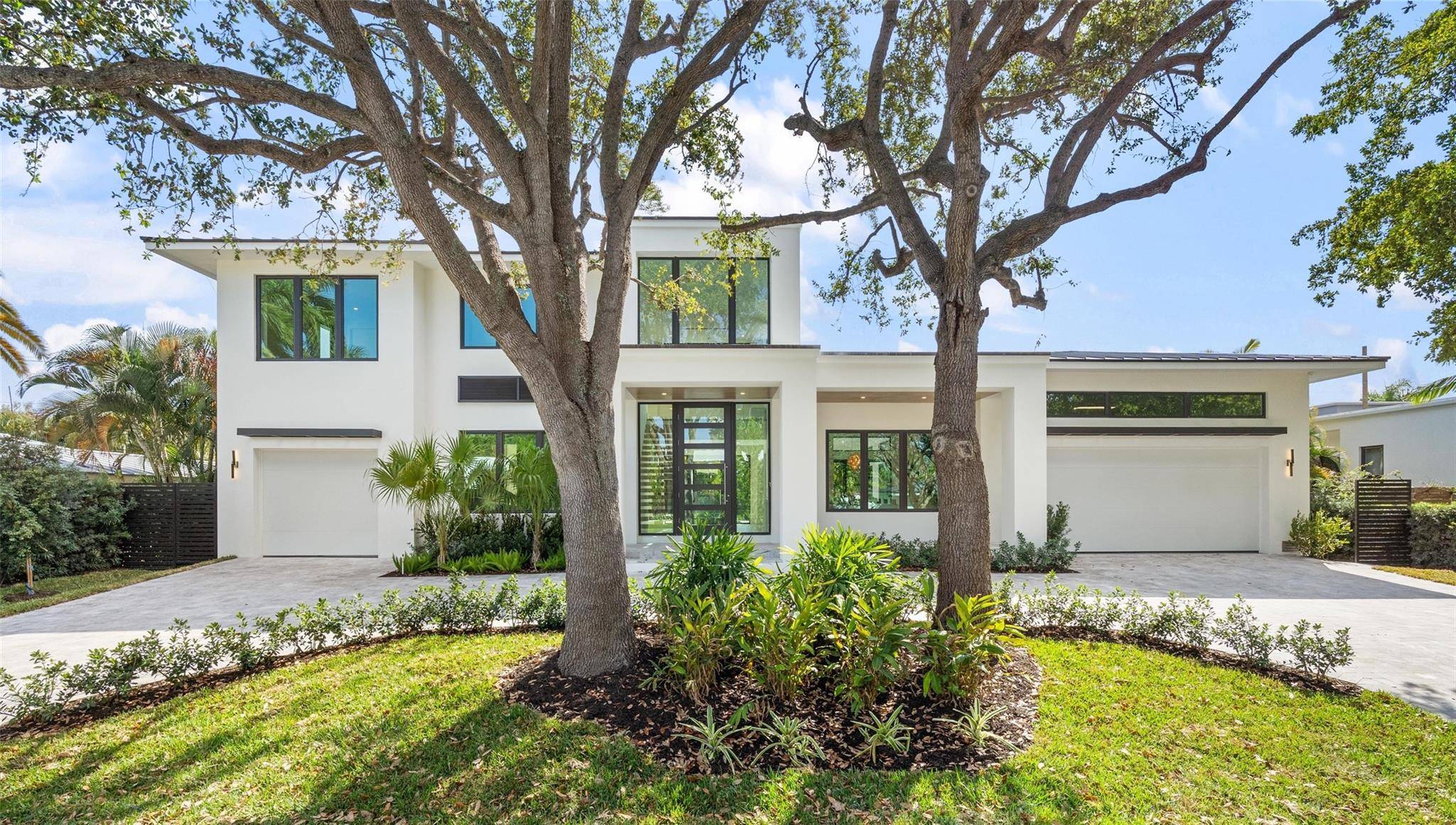 One of the only courtyard design homes in Coral Ridge, this architectural masterpiece completed in 2026 delivers true privacy bathed in incredible natural light.