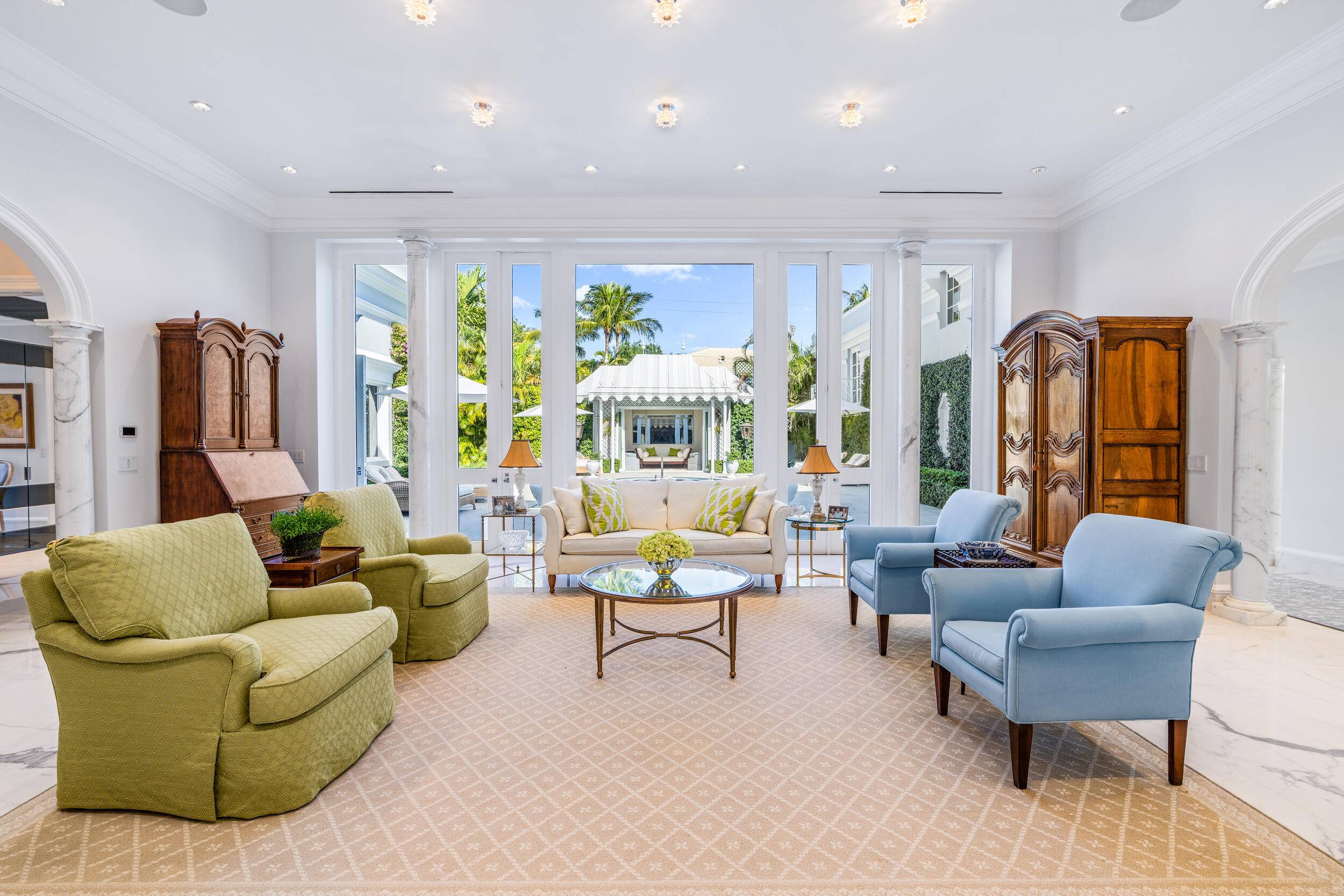 Regally elevated at 16' on over half acre this proper Palm Beach Palladian residence renovated in 2022, showcases quintessential architecture set within beautifully landscaped pool gardens.