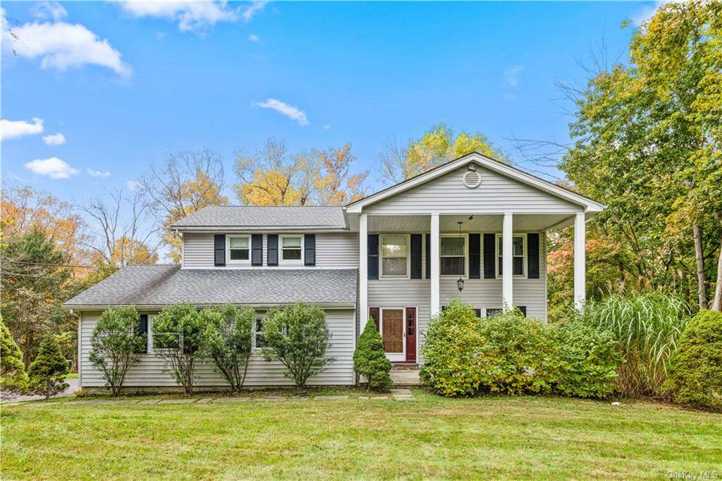 Drive into a secluded circular driveway tucked away from the road in a peaceful, tree lined neighborhood.