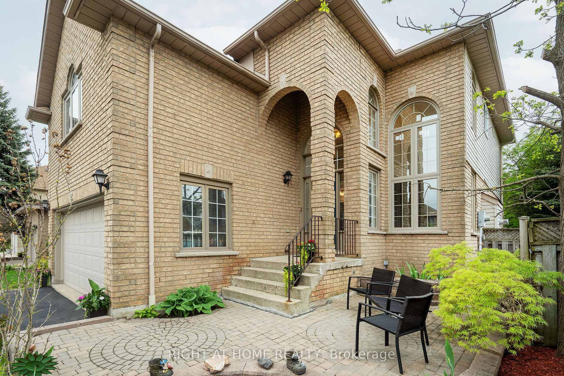 This impressive two storey home offers a bright and spacious layout with soaring windows, a gas fireplace, elegant French doors, and a welcoming main floor design.