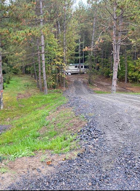 This property features a new driveway leading to a clearing where a 36 ft 1997 Winnebago Bounder is located on over 27 Acres of property located west of Loring.
