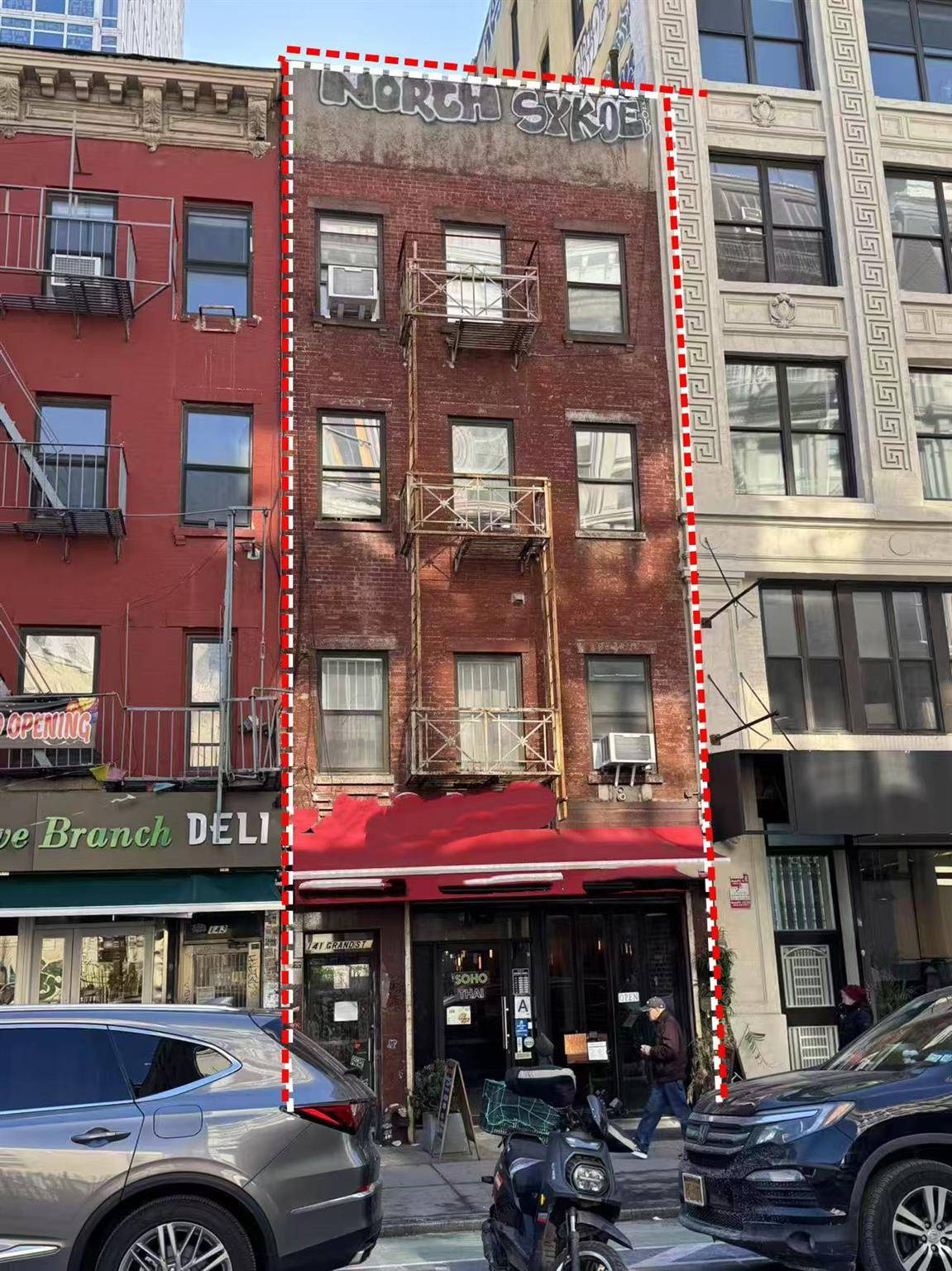 A multi family building with a ground floor retail space, featuring four residential units, located in the heart of Soho.