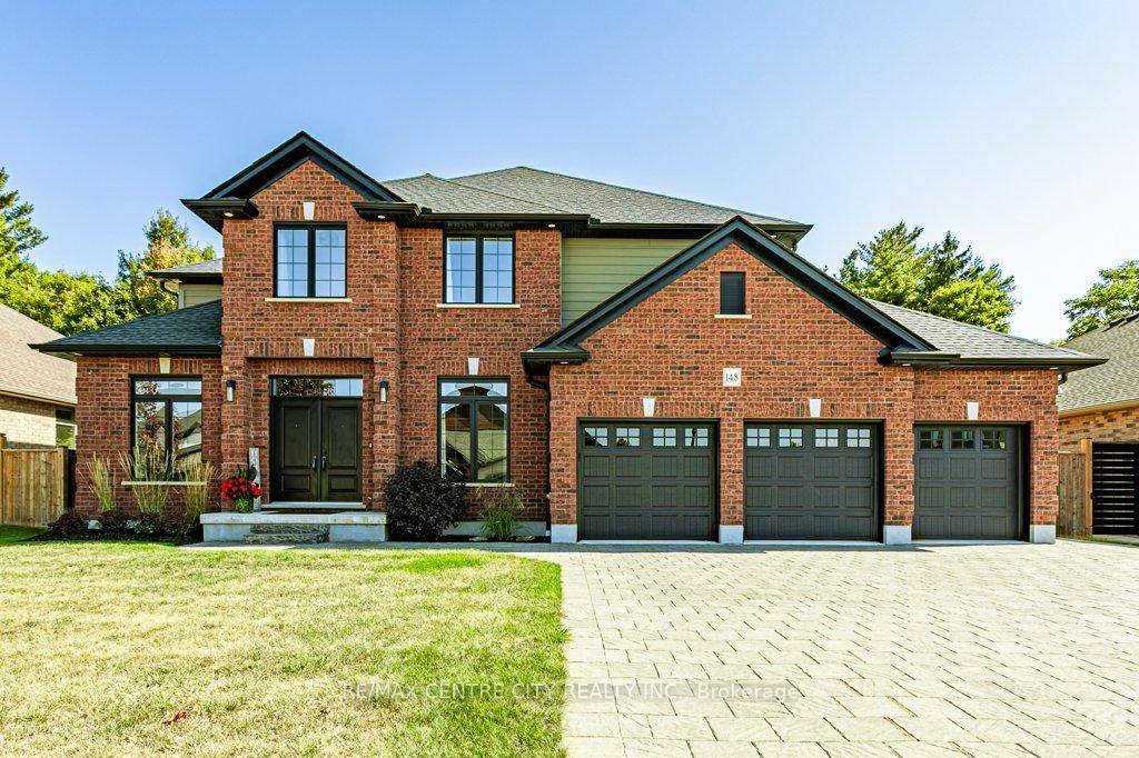 148 Elliott Trail, a stunning red brick home located in the desirable Trails of Wye Creek neighbourhood in Thorndale, Ontario.
