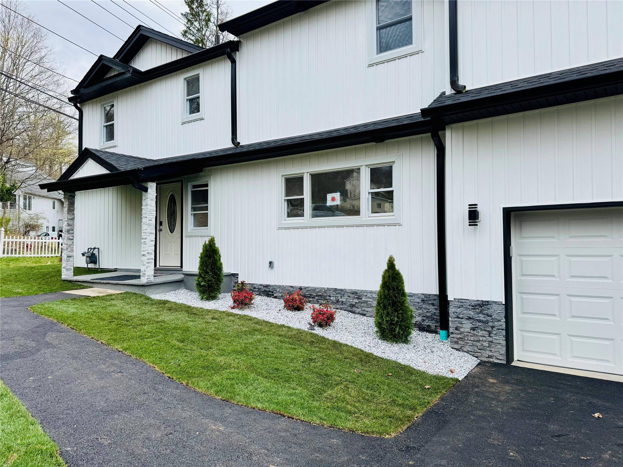 Spacious new construction 4 bedroom, 3 bathroom farmhouse colonial featuring modern finishes and classic charm.