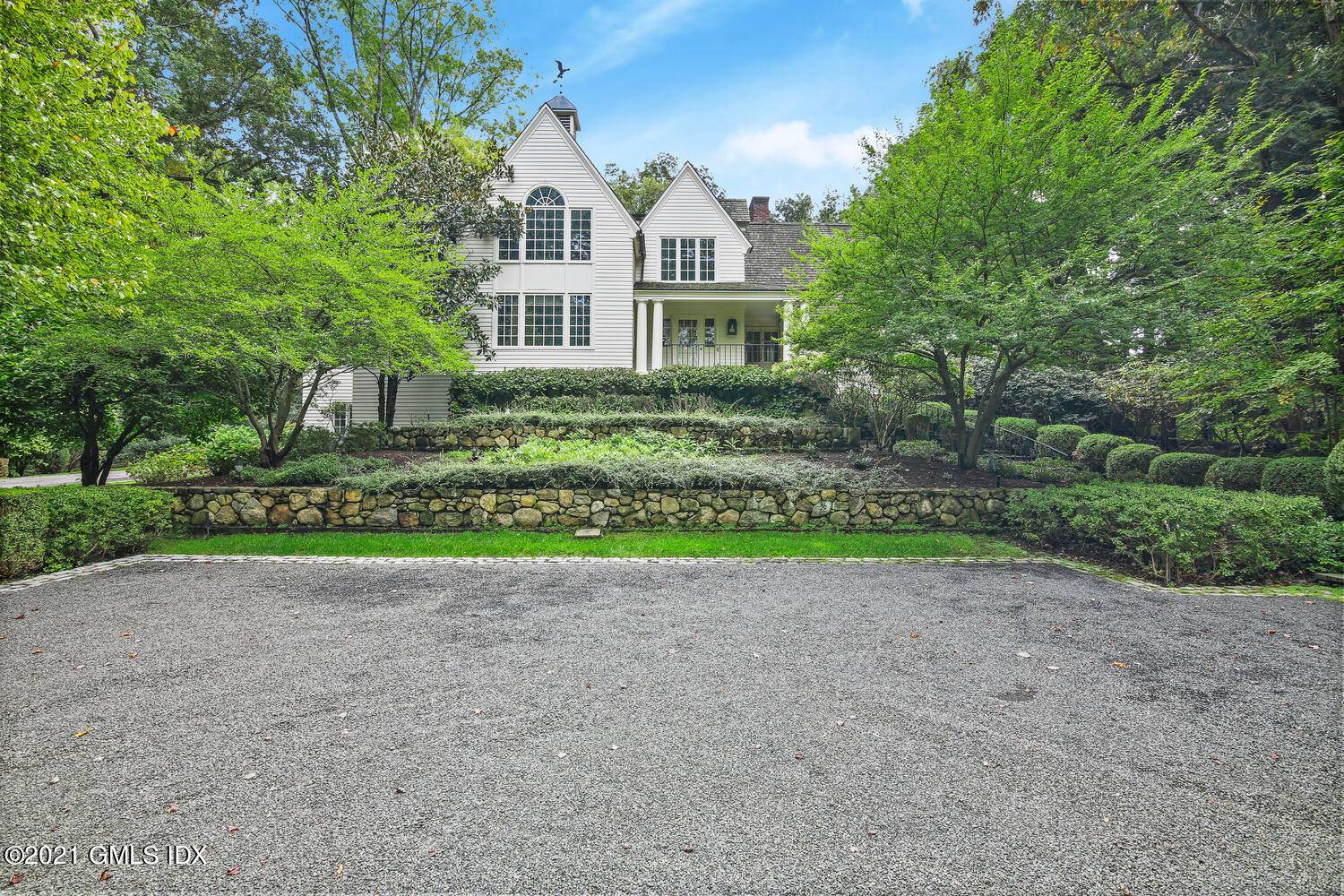 Classic gates lead to a private sanctuary on 5 lush acres of professionally landscaped lawn.