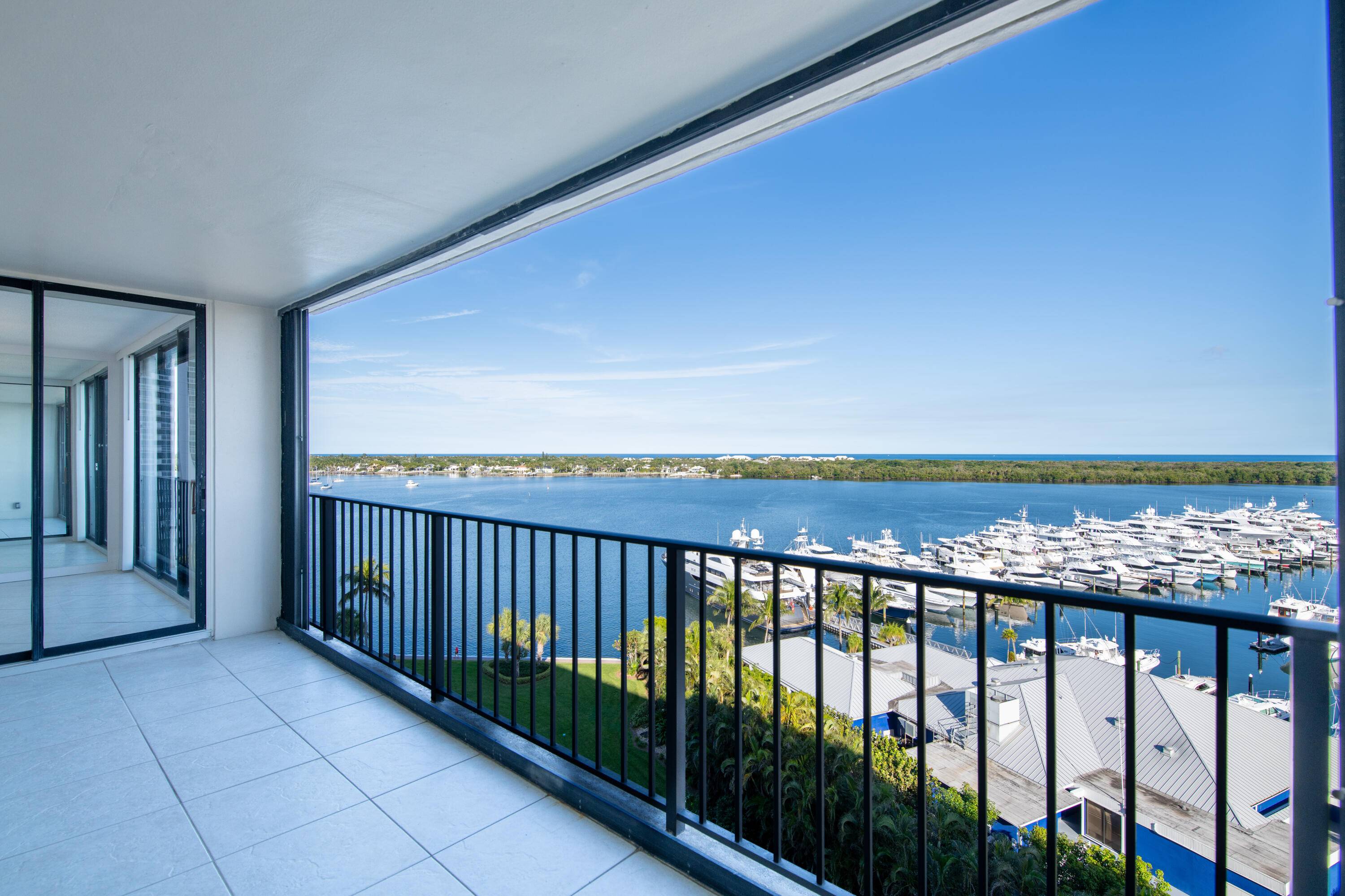 Rarely available, this 11th floor condo at 122 Lakeshore Drive offers unparalleled, unobstructed panoramic water views in the prestigious gated community of Old Port Cove.