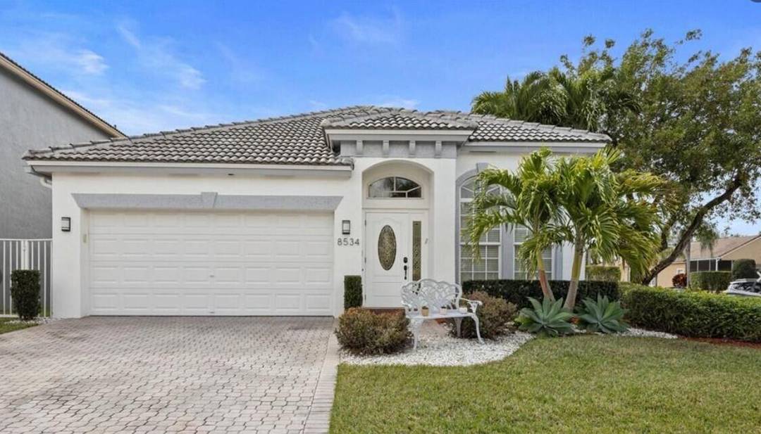 Beautiful corner lot home located in the highly desirable gated community of Mizner Pointe !