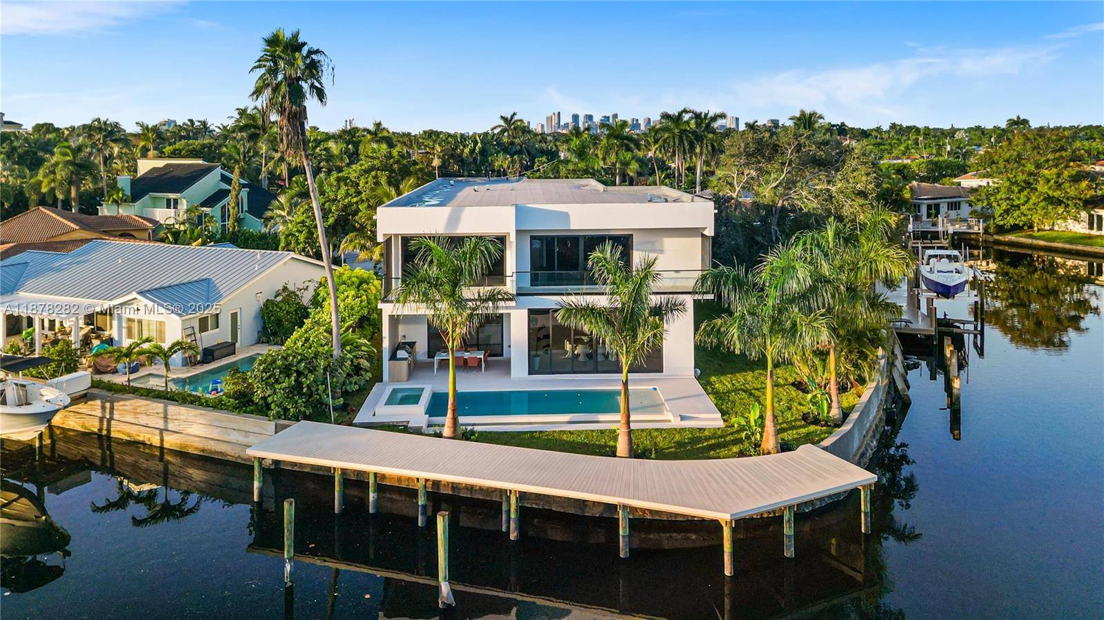 Theres a moment standing at 2033 NE 22nd St, where the water stretches wide with 160 ft of frontage and a bold new home rises before you.