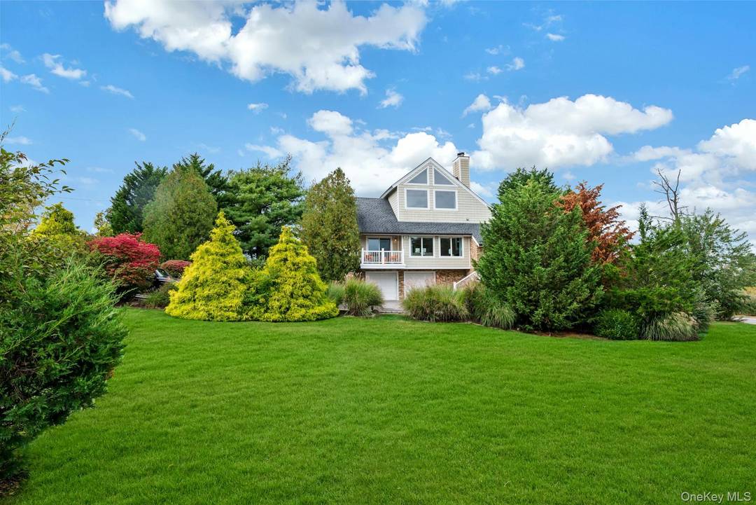 Experience refined Hamptons living in this exceptional Hampton Bays Post Modern retreat on coveted Old Canoe Place Road.