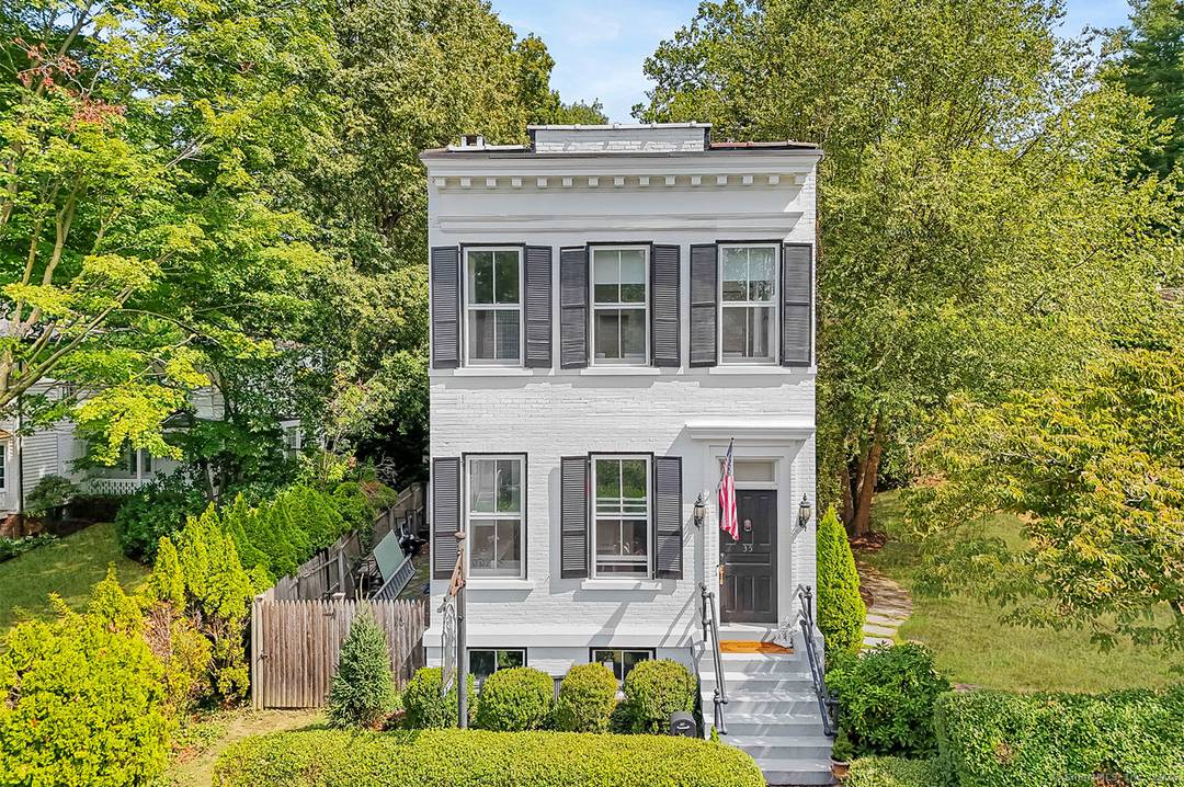 Step into a one of a kind opportunity at 35 Rose Hill Road a charming white brick antique originally built in 1912 as the Southport Telephone Exchange.