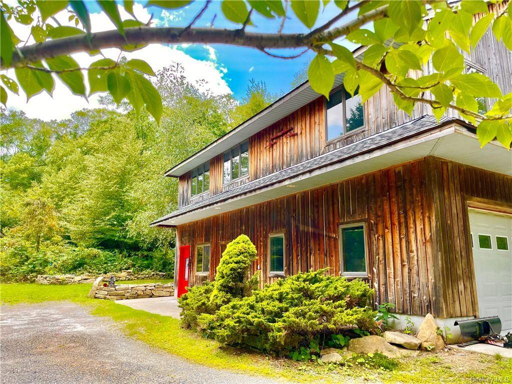 Adirondack style contemporary house not only borders protected land, it also has lake rights to pristine Whaley Lake.