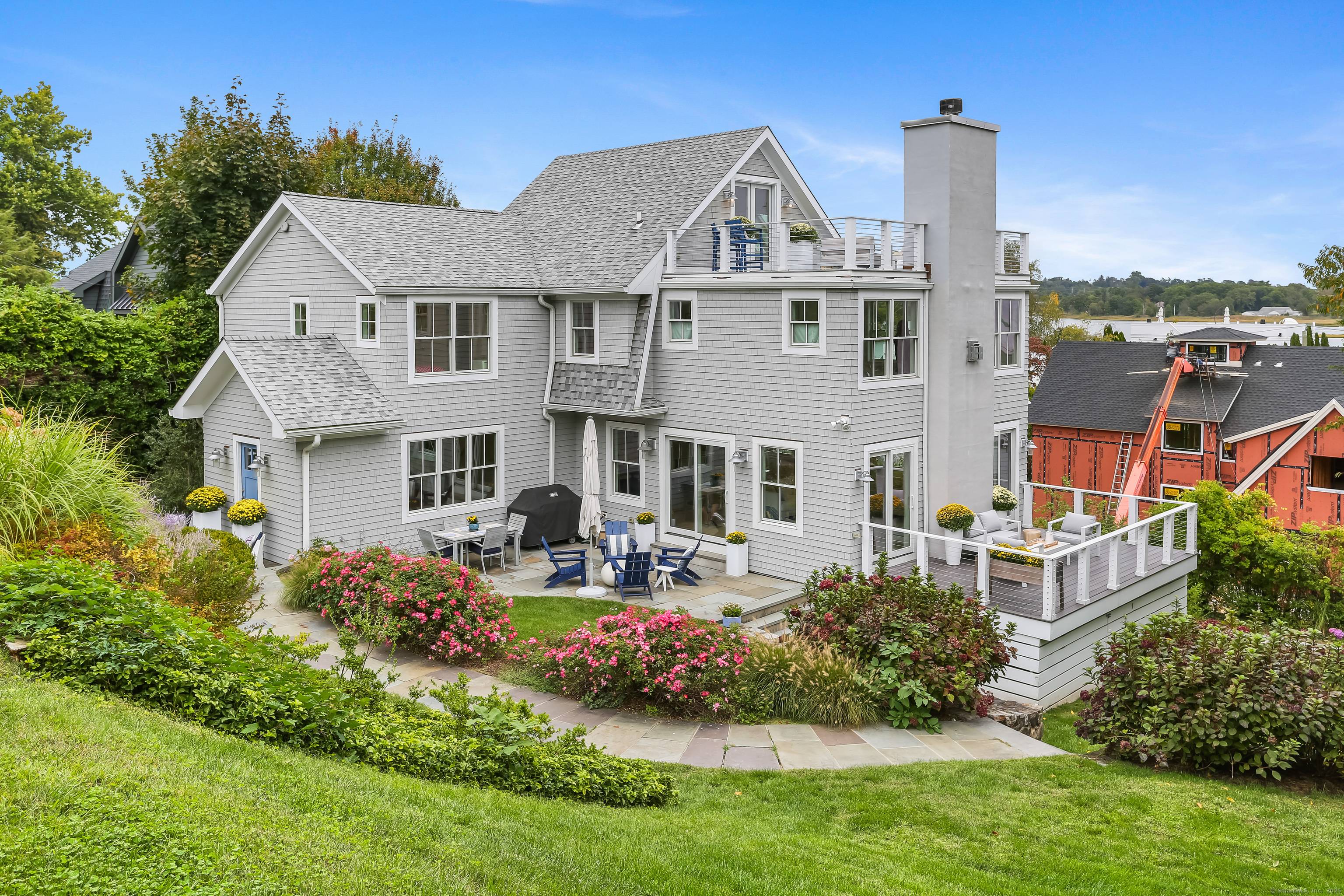 Nestled in privacy by nearly 100 arborvitaes, this ultimate retreat on a rare double lot is just steps from Old Mill Beach Compo Beach.