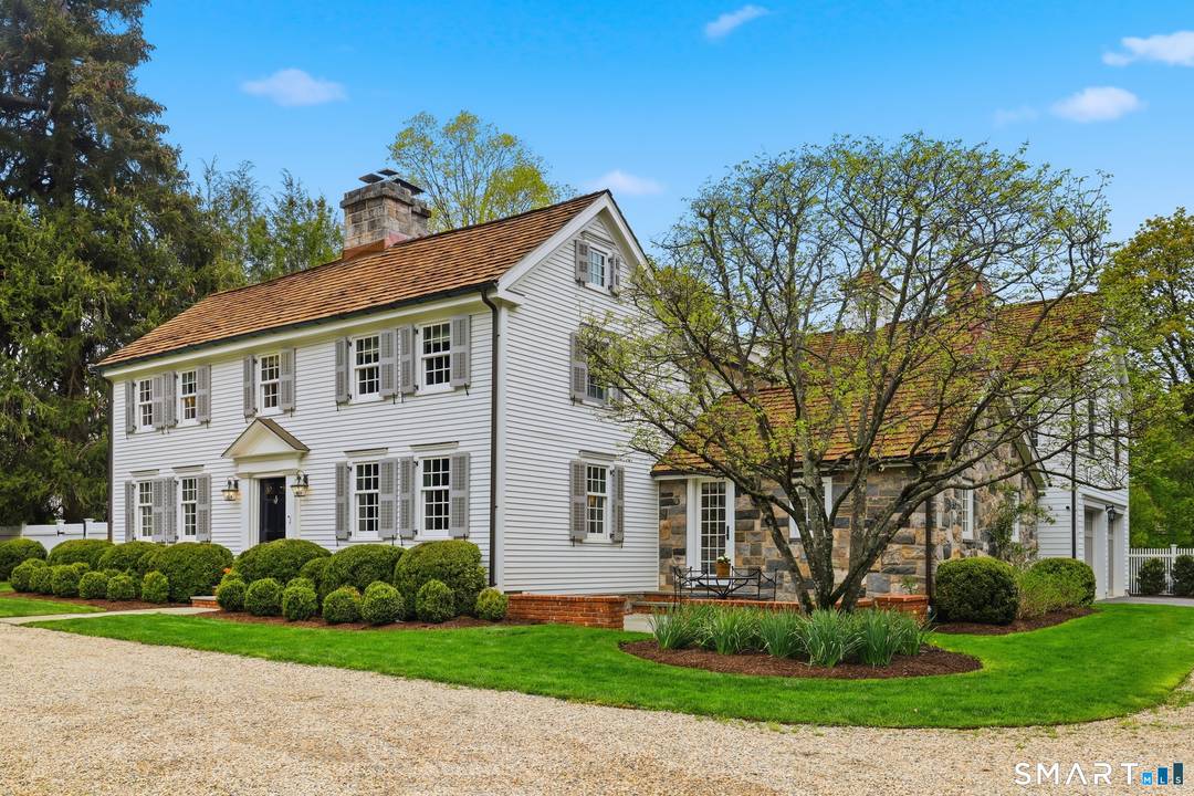 Thoughtfully renovated and expanded, this remarkable five bedroom, four and a half bath Colonial offers a refined blend of historic character and modern sophistication.