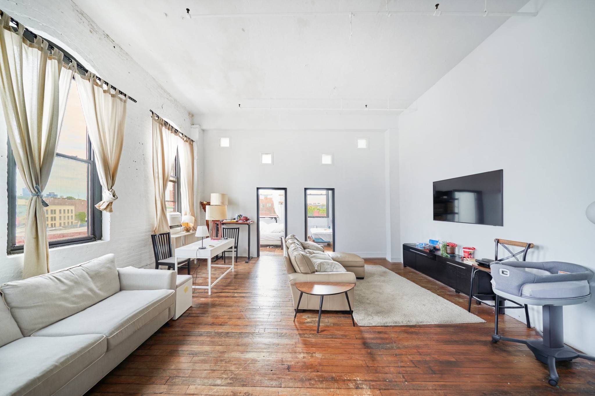 FEATURES 8 oversized arched windows wrap around this rare corner loft providing tons of sunlight 1000 of creative living and work space with exposed brick throughout Large sleeping loft wit ...