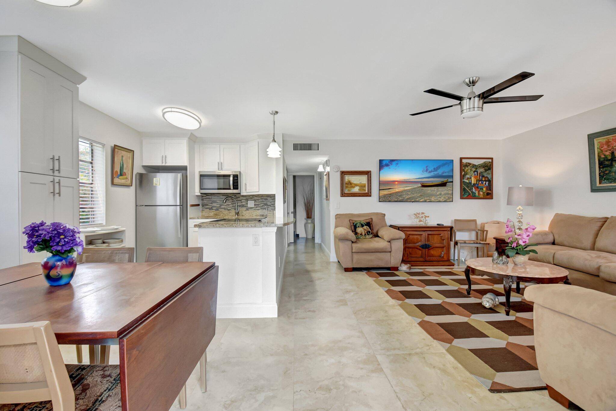 Beautifully remodeled first floor home with lovely garden view from screened patio !
