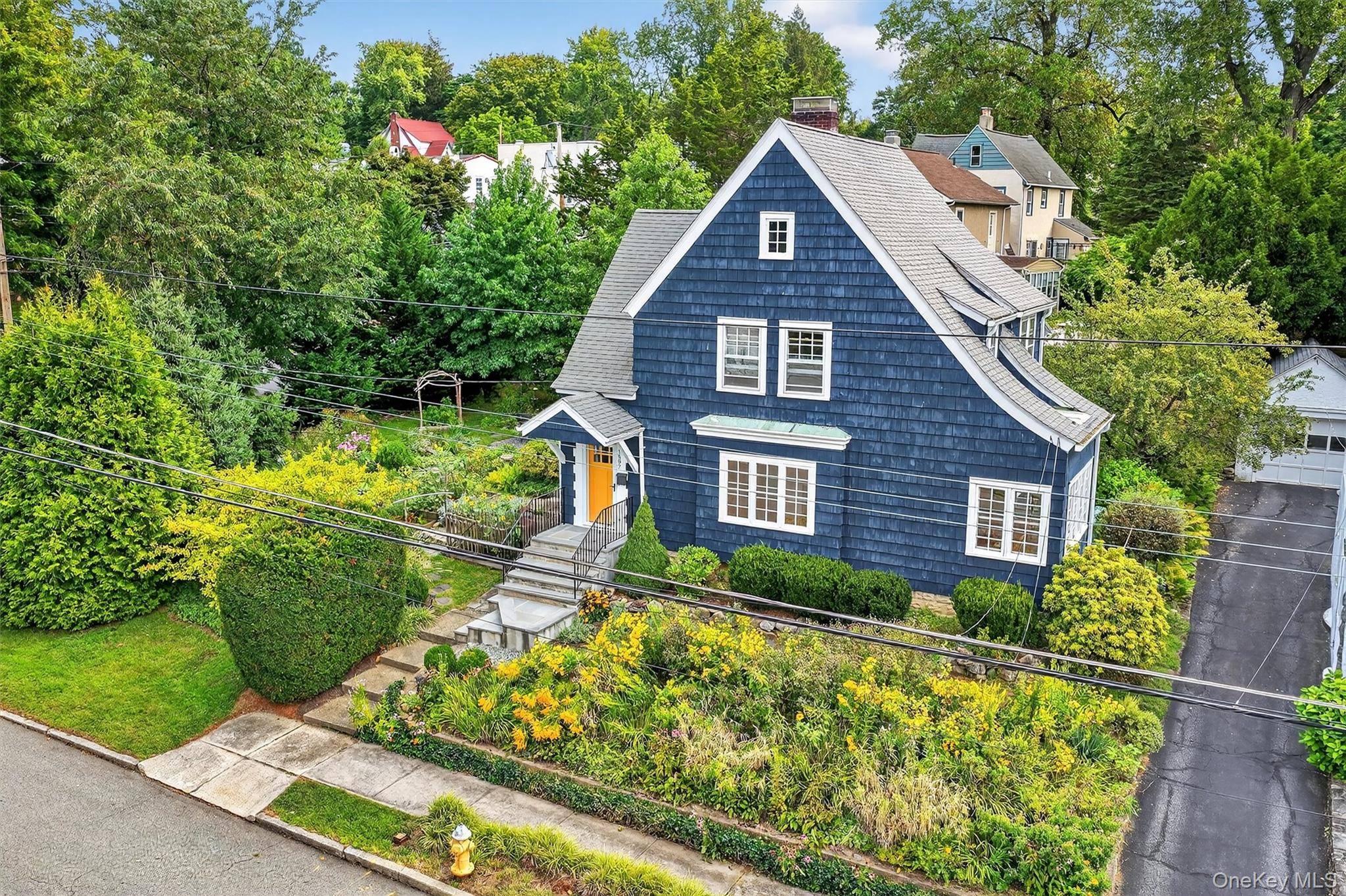 Nestled in the exclusive and sought after Mortgage Hill neighborhood of Peekskill, this charming 1933 Tudor style home blends timeless character with serene surroundings.