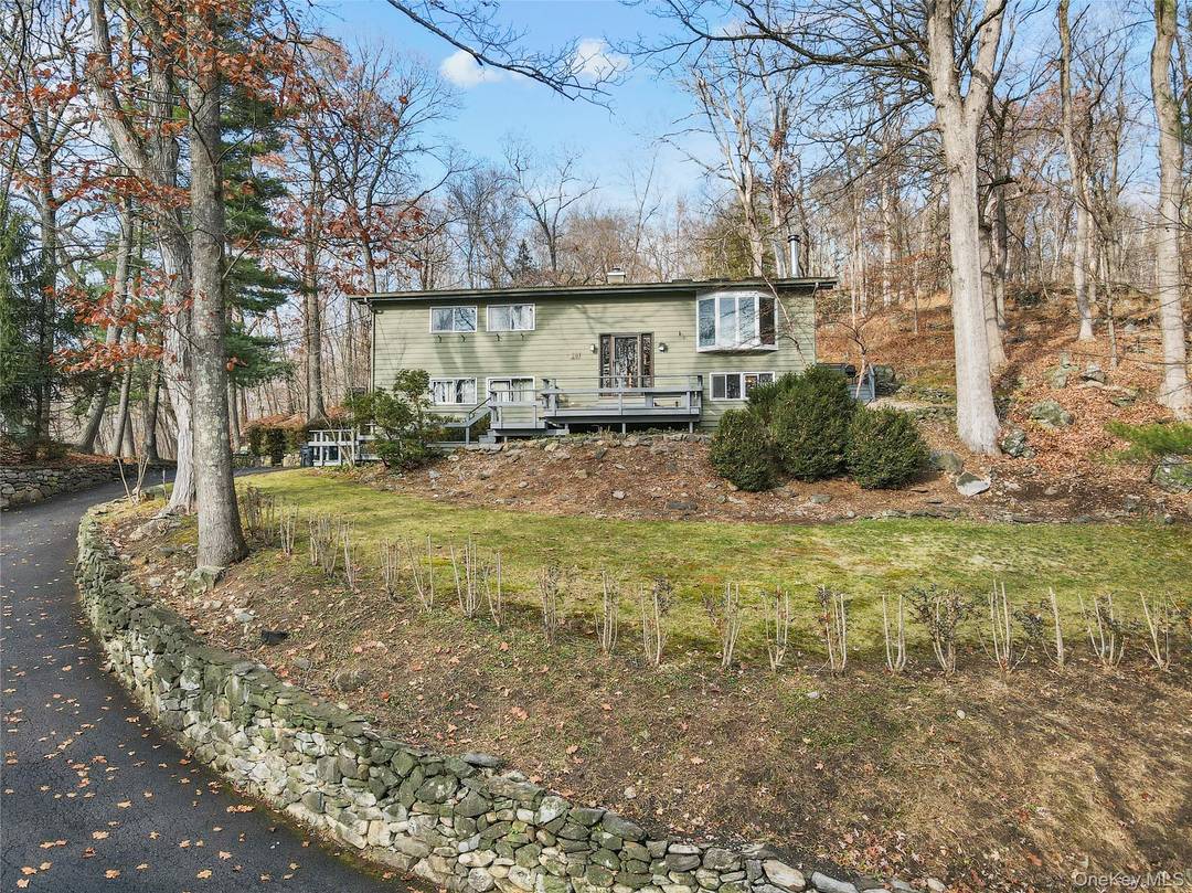 Lovely, sunny Katonah house on a wooded hilltop with easy access to train, shopping, schools.