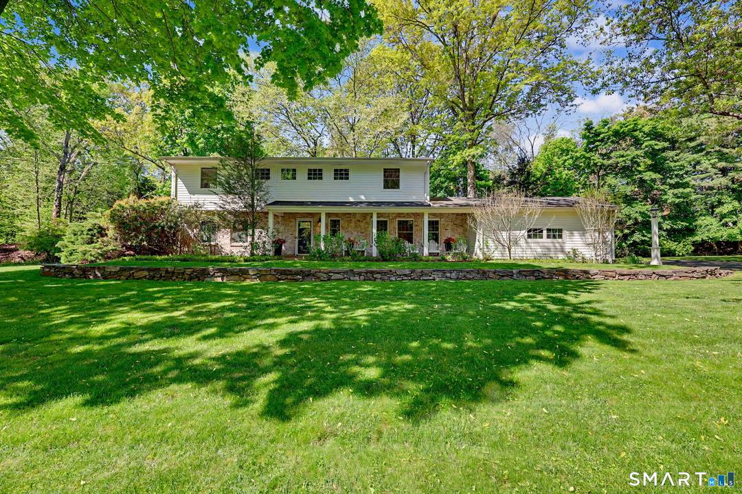 Welcome to 10 Grist Mill Lane, a move in ready home set on a beautiful, level acre at the end of a quiet Long Lots cul de sac.