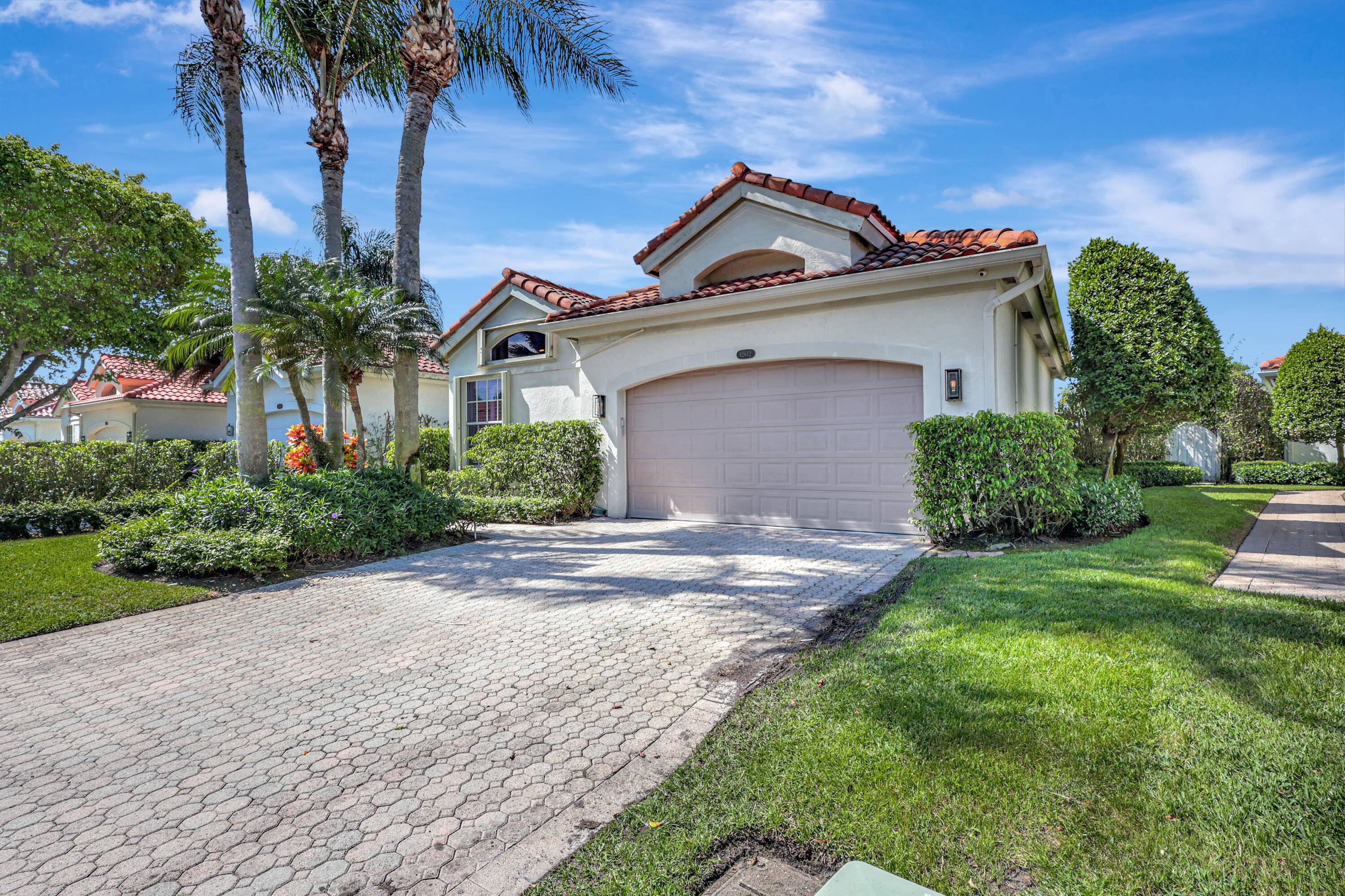 Located in the exclusive Palm Beach Polo 24 hour man gated community, this beautifully remodeled home offers an open kitchen, abundant natural light, and stylish decor throughout.