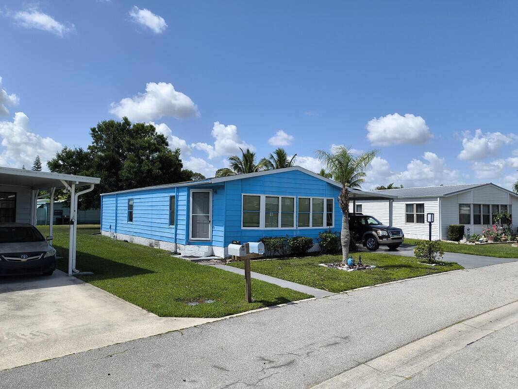 This manufactured home is located in the La Buona Vita Co op community in Port St Lucie Florida.