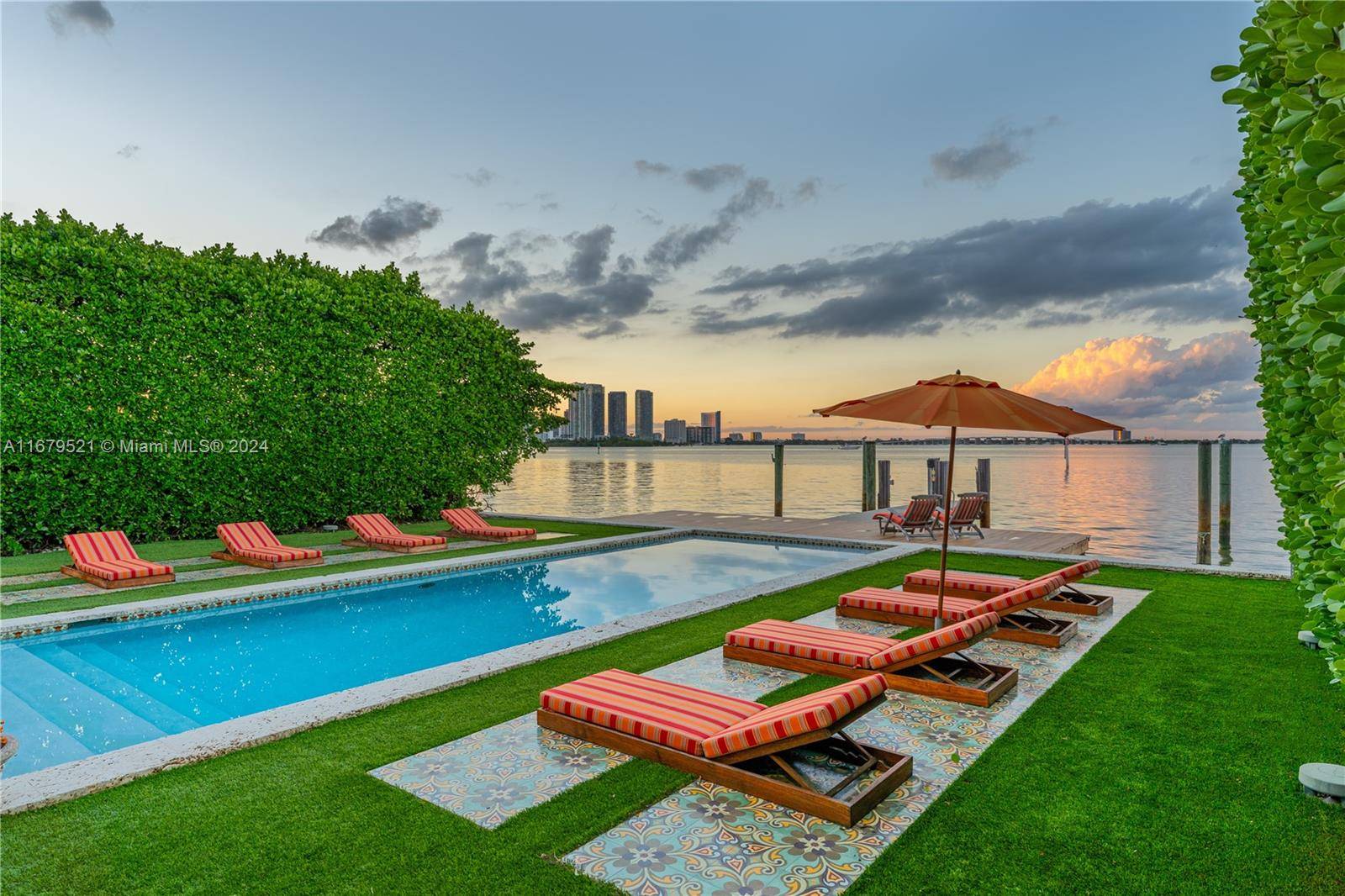 Elegant tropical contemporary waterfront residence on the wide open waters of Venetian Islands offering dramatic sunsets and sought after skyline views !