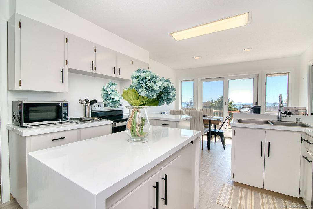 Enjoy stunning vistas of Fishers Island Sound from this hilltop property in Noank.