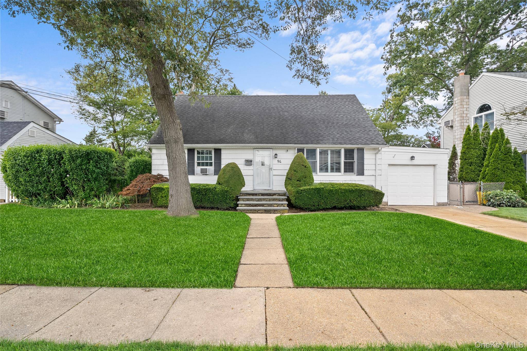 Welcome to Charles Avenue in the heart of Massapequa Park, a spacious and beautifully maintained expanded cape offering a rare opportunity with two additional lots included in the sale.