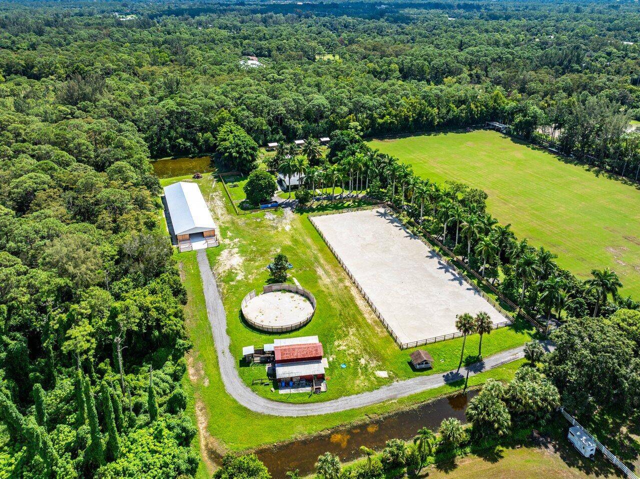 An equestrian paradise just minutes from the Wellington Equestrian Festival, this exceptional estate is a dream come true for horse enthusiasts and those seeking ultimate tranquility.