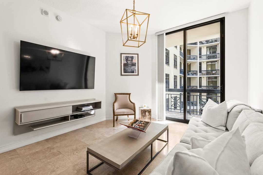 Penthouse level 2 bed 2 bath residence featuring high ceilings and a southeast facing balcony with courtyard views.