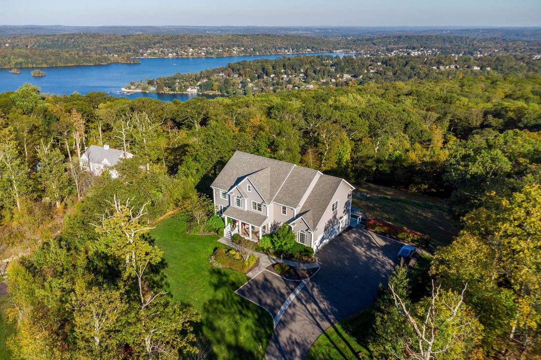 Perched high above Candlewood Lake, this extraordinary custom built residence was crafted by a six time HOBI Award winning builder for himself and embodies the finest craftsmanship with timeless sophistication.