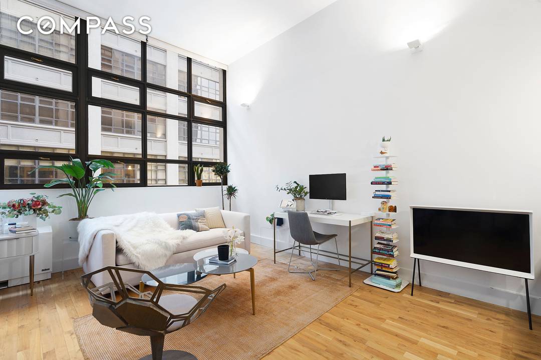 Stunning 583 approx. S F studio condo with 13' soaring ceilings and enormous windows, flooding the space with light and offering a slight park and harbor view.