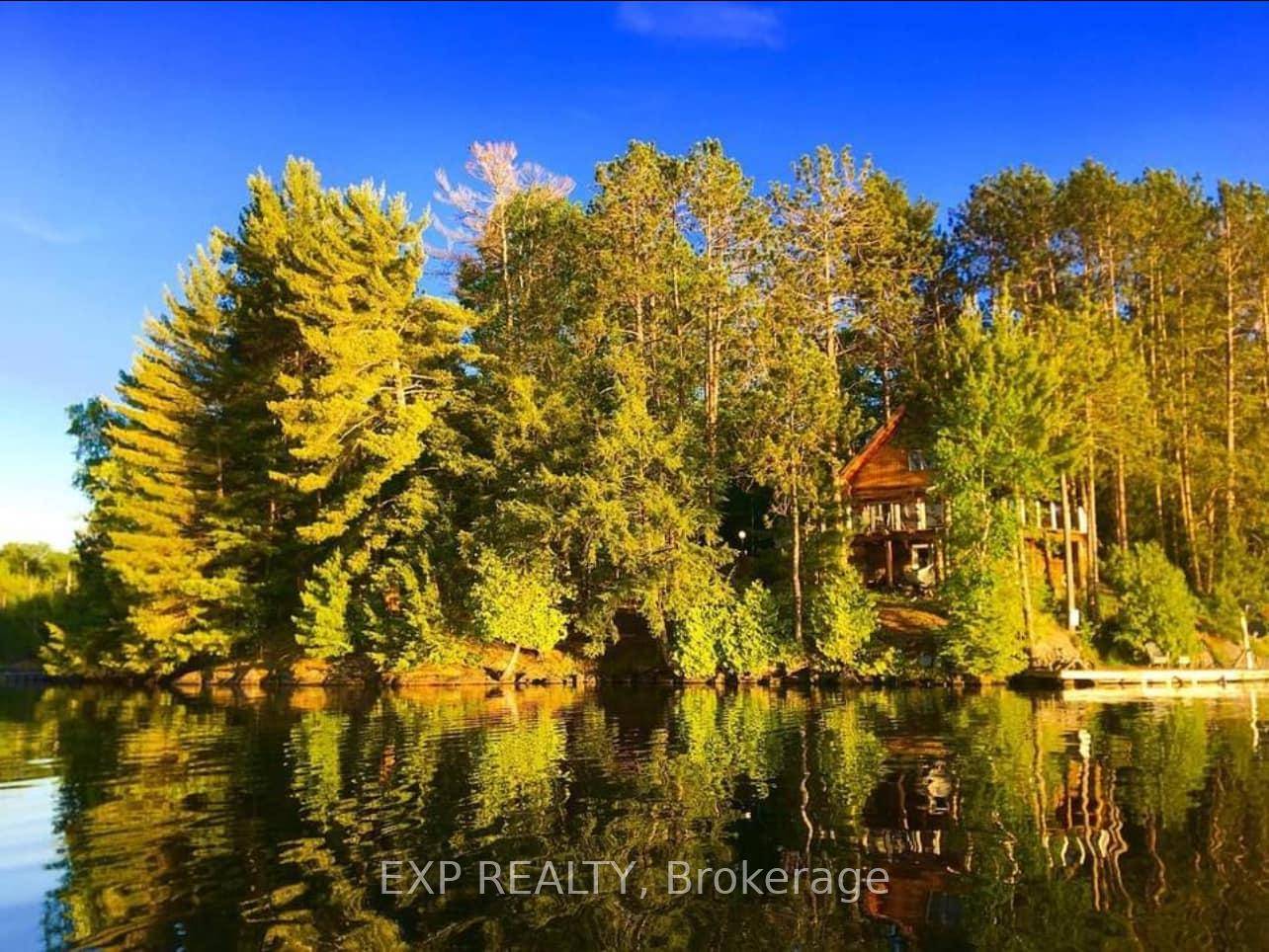 Nestled on a stunning 9 acres property along 1479 feet of pristine shoreline, this custom built log home is the ultimate retreat for nature lovers and those seeking tranquility.