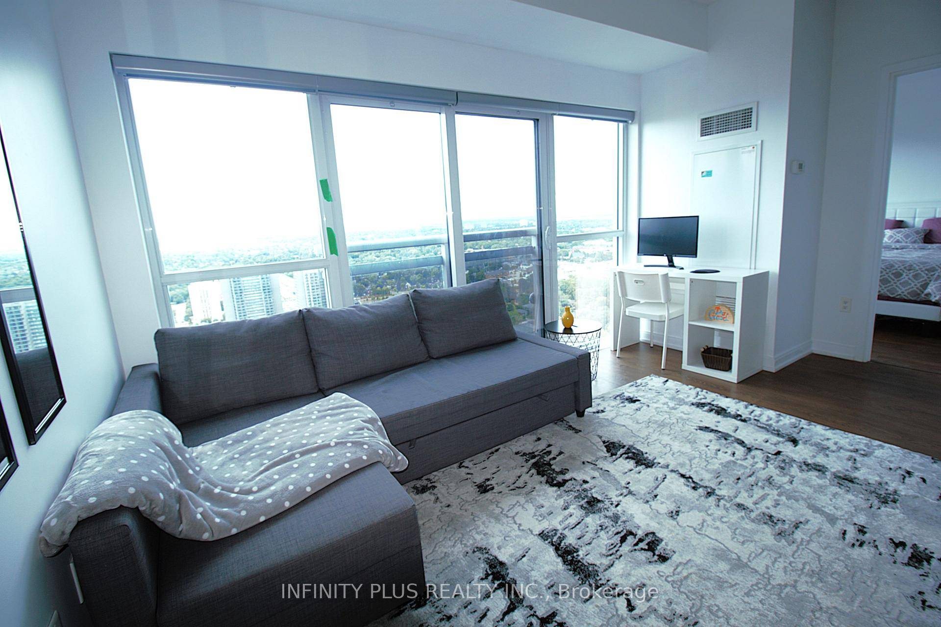 A Luxury Condominium offering a spacious 1 bedroom, 1 bathroom unit perched on a high floor with soaring 9' ceilings and large windows showcasing stunning city views.