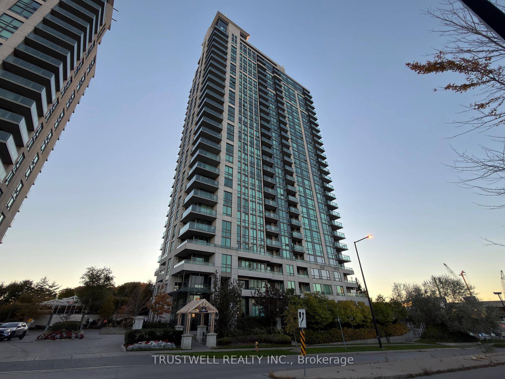 Modern 2 bed, 2 bath condo with bright open concept living, wide windows, and a sleek kitchen with stone counters and stainless steel appliances.